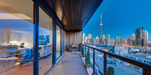 View of Toronto CN Tower and skyline from luxury condo unit.